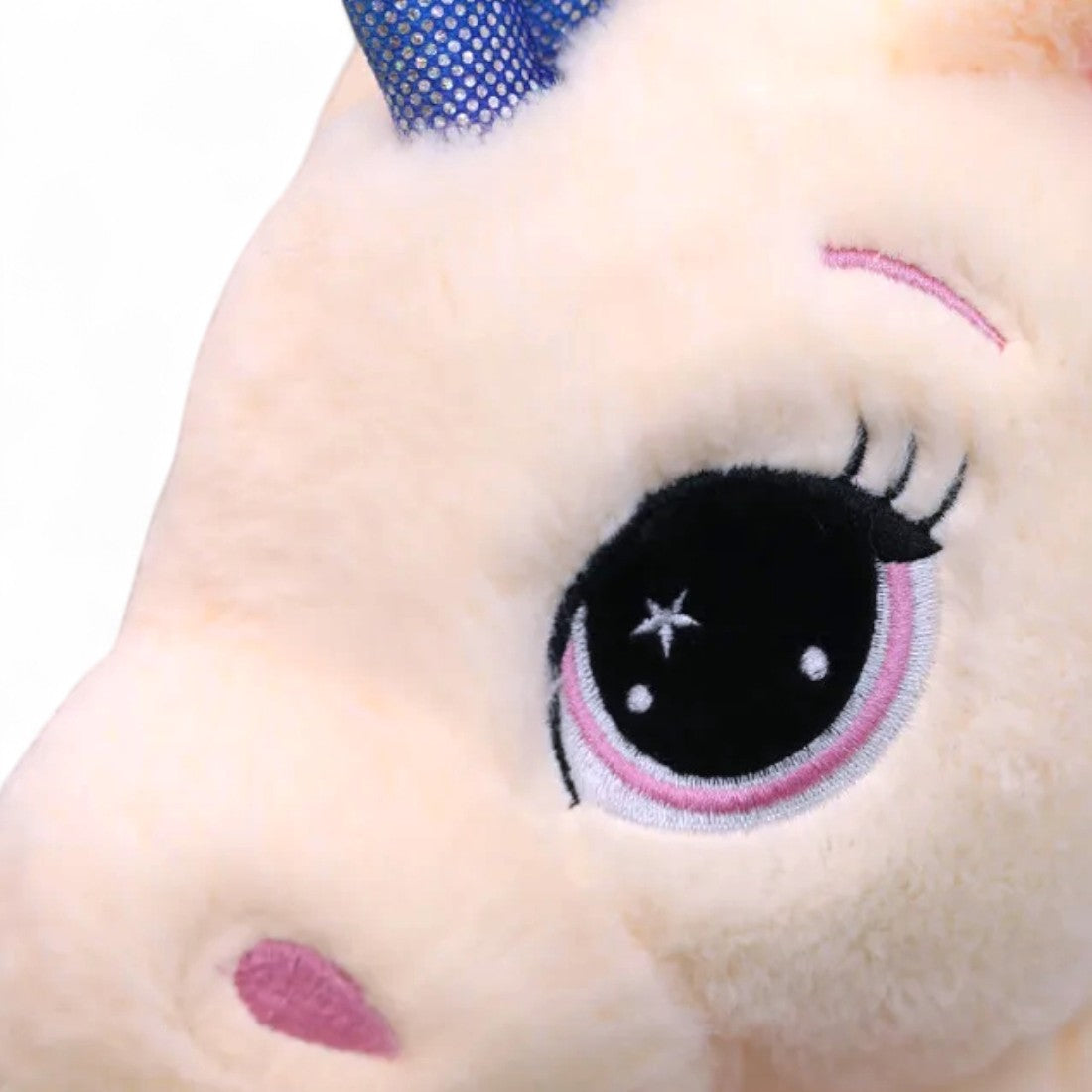 Peluche unicorno arcobaleno disteso