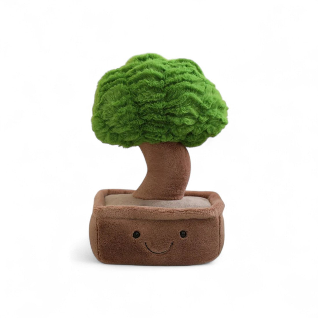 Peluche pianta kawaii a forma di bonsai sorridente con vaso marrone e fogliame verde, posato su sfondo bianco.