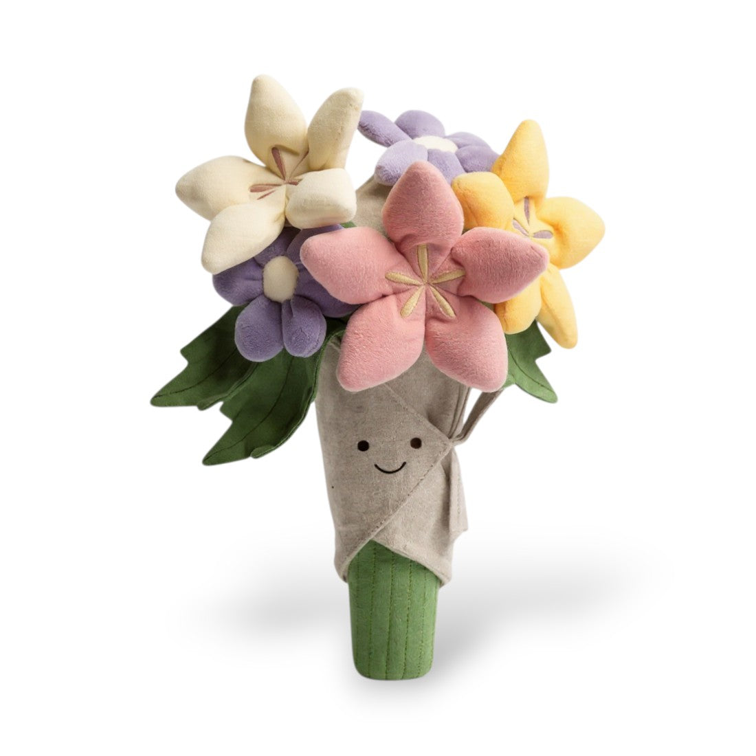 Un peluche a forma di bouquet di fiori multicolore (giallo, rosa, viola, bianco, beige) in un cono di carta beige con viso sorridente dai grandi occhi, foglie verdi e base verde, su sfondo bianco.